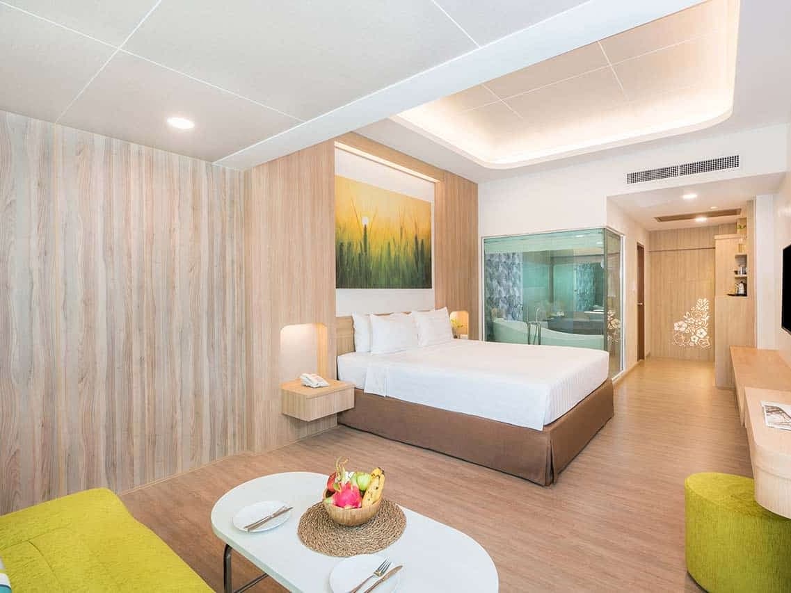 A deluxe villa at a beachfront resort on Chaweng, bed and sitting area in one room